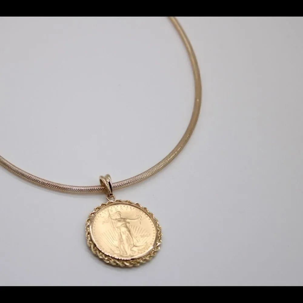 New 22k gold American Eagle 1/2 ounce coin mounted in 14k gold coin bezel